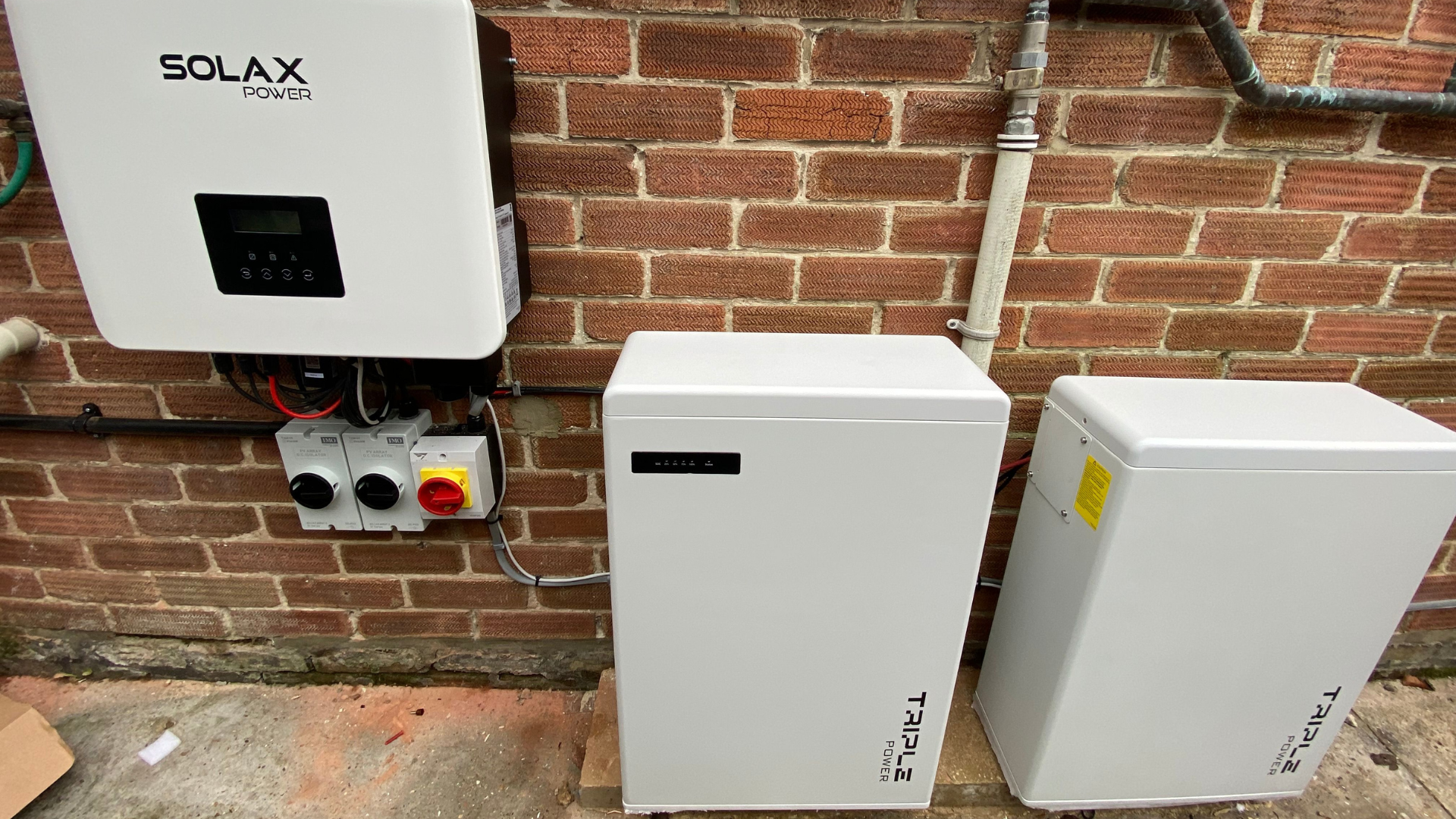 An image of a Solar PV inverter and battery install on a typical domestic property 