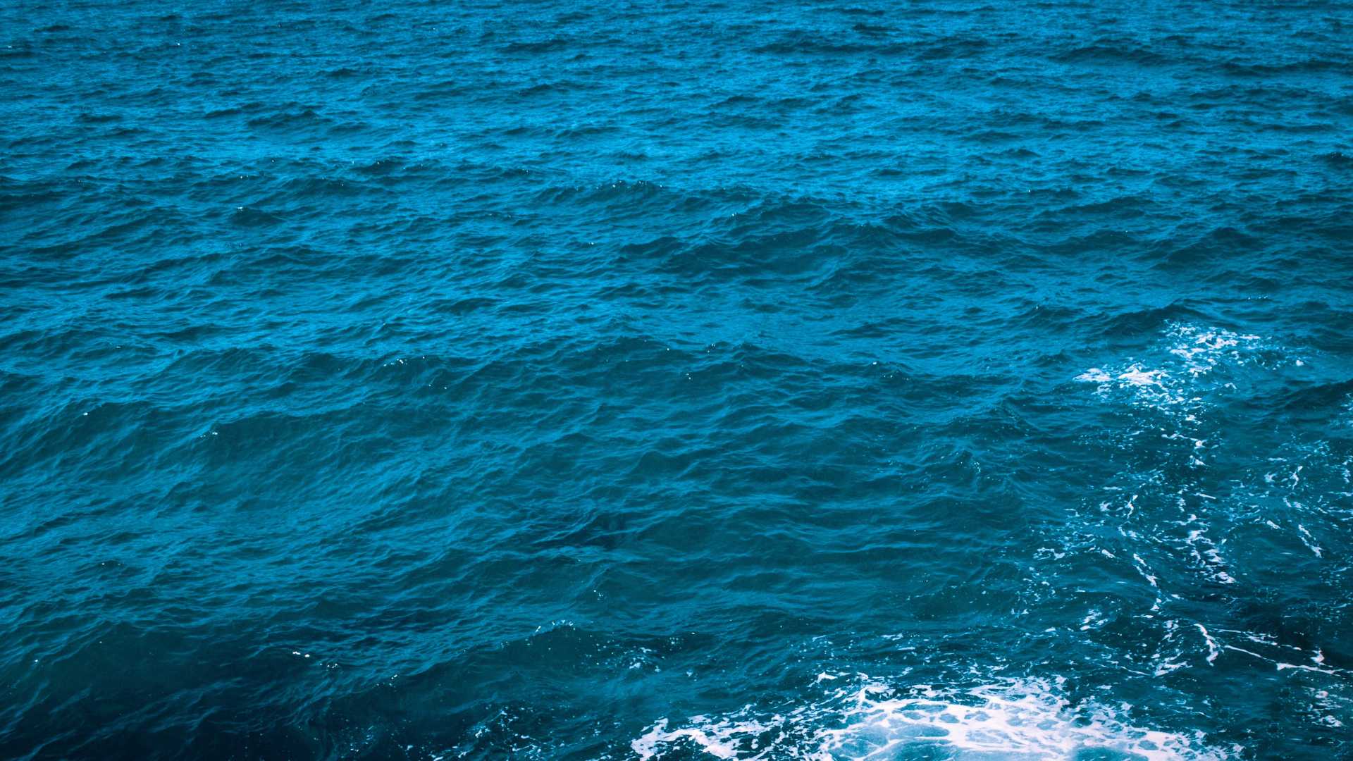 An image of water in the ocean with a very blue tint 